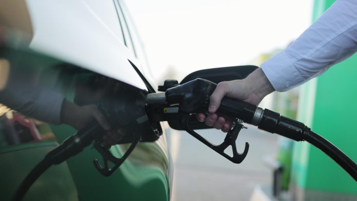 Filling car with gas fuel at station pump. Car filling up with fuel. Diesel Oil. Gas nozzle in car's fuel tank. Fuel, gas station, petrol prices concept.