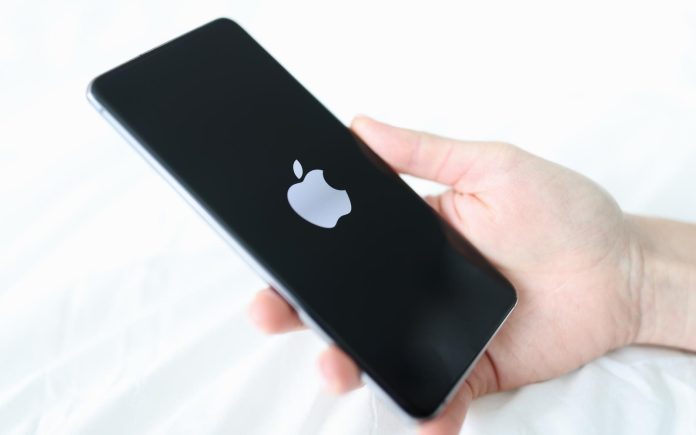 Hand holding new iPhone 13 pro closeup