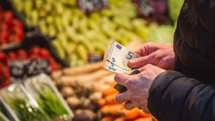 Man takes money out from wallet on market