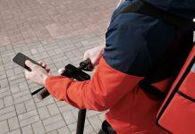 Just Eat Faces UK Competition Watchdog Probe on Misleading Reviews Food delivery app interface showing customer reviews and ratings on smartphone screen