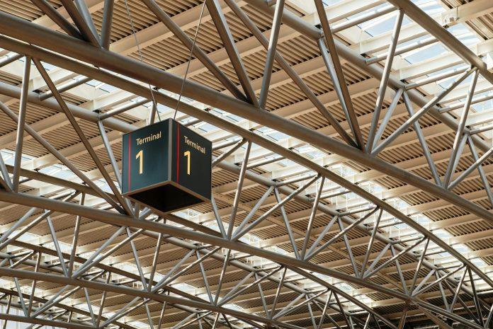Irish passengers at Dublin Airport terminal preparing for summer holiday travel with luggage and boarding passes
